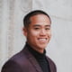 A young man smiling at the camera.